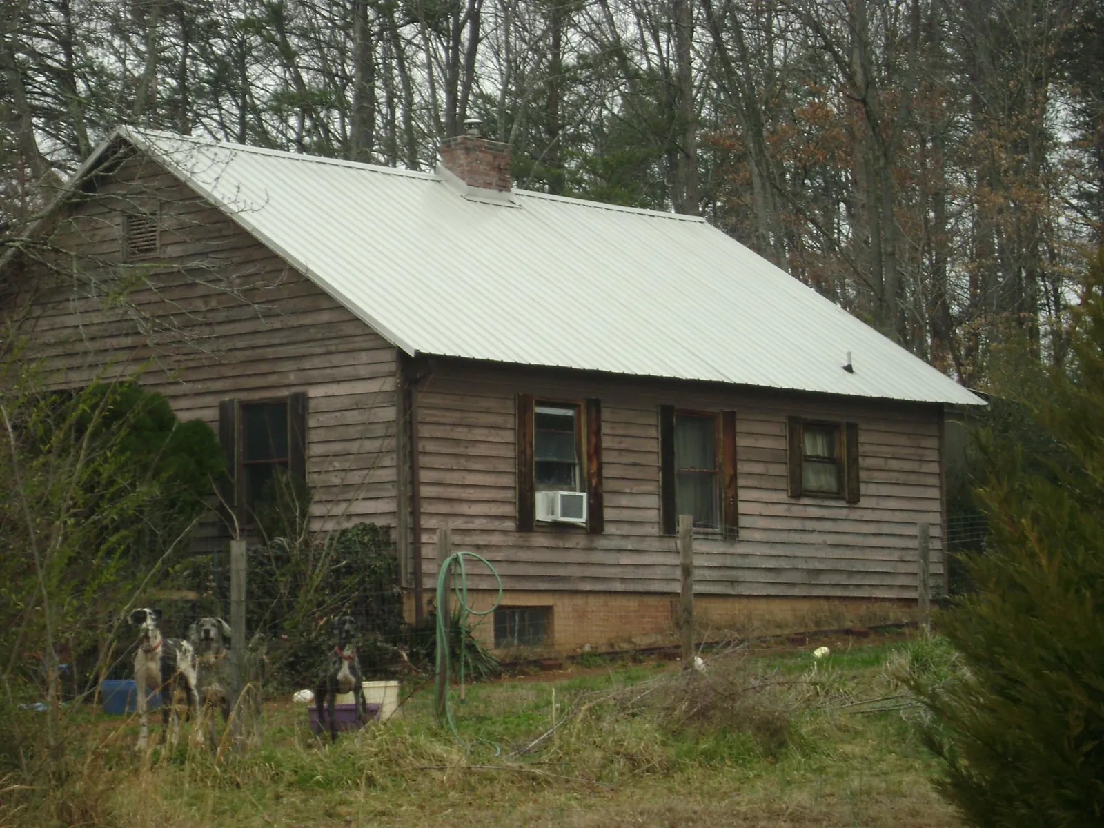 White metal roof on an old wood sided farmhouse, from a Metal Roof Installation job in Mchenry